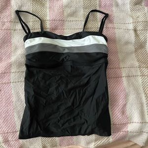 Black tankini top. Size M. Never worn. Straps come off! In perfect condition!